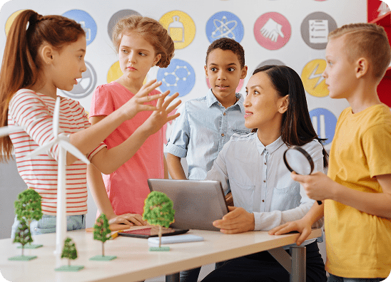 Children discussing science projects with teacher.