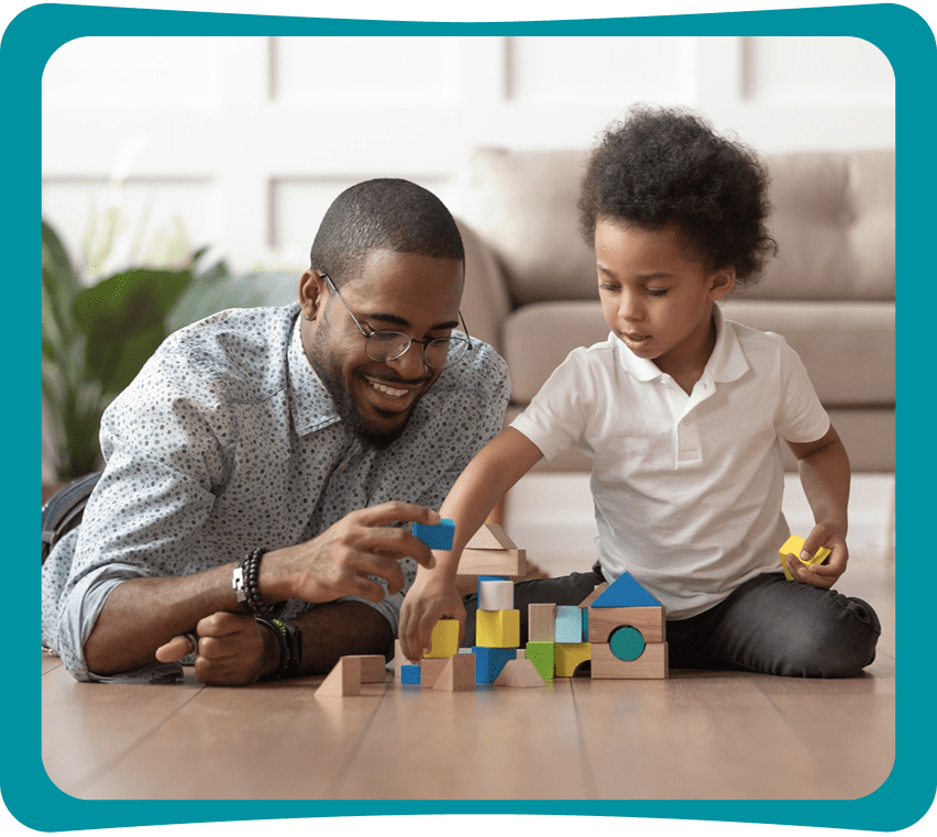 Father and child playing with building blocks.