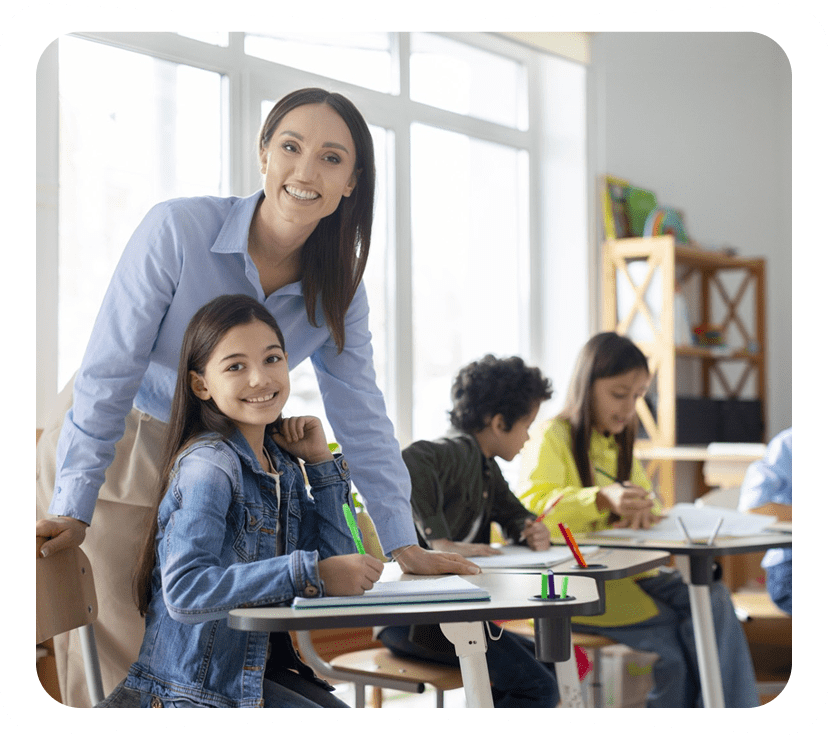 Teacher and students smiling in classroom setting.